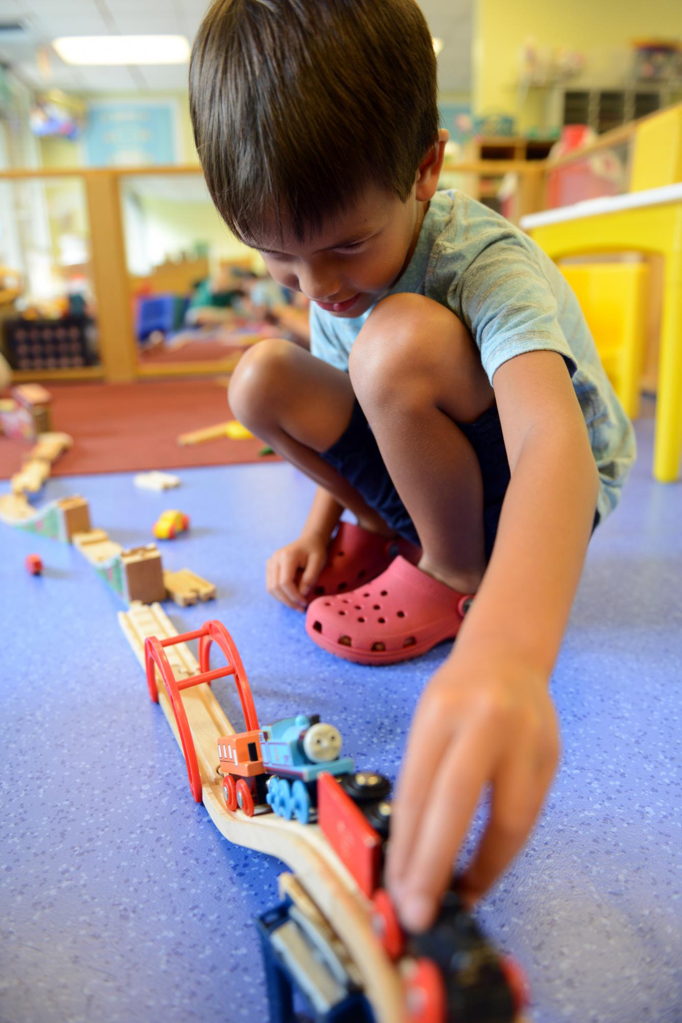 Young boy playing with a train