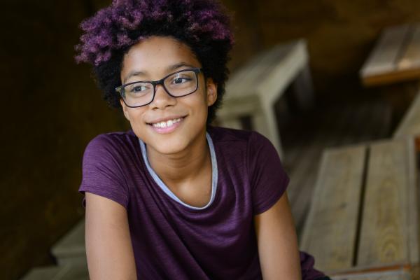 Teenager smiling while looking away from camera