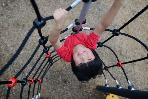 Young boy climbing a rope tower