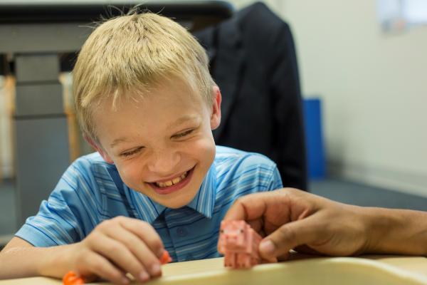 Boy playing with small toy