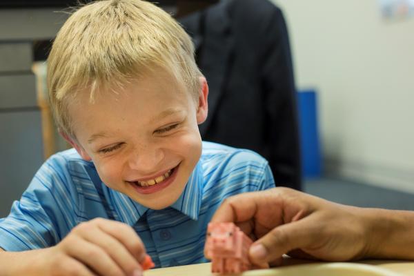 Smiling child holding small toy