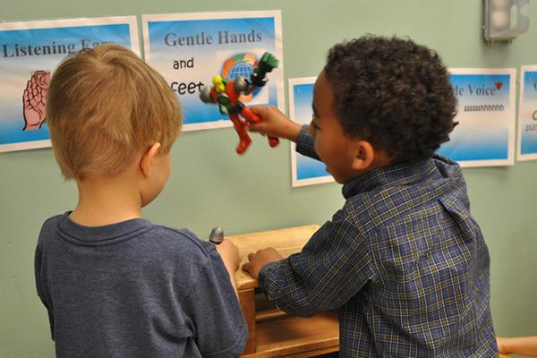 Two boys of different races in a classroom