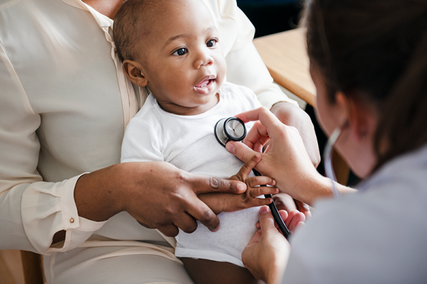 Doctor examining young child