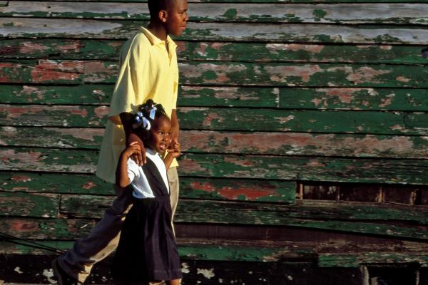 Older boy walking with younger girl