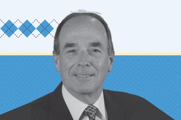 Black and white headshot style photo of Sam Odom with Carolina and light blue background and blue argyle accent