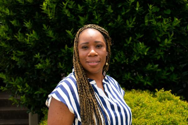 capri banks; woman with long braids wearing blue and white blouse