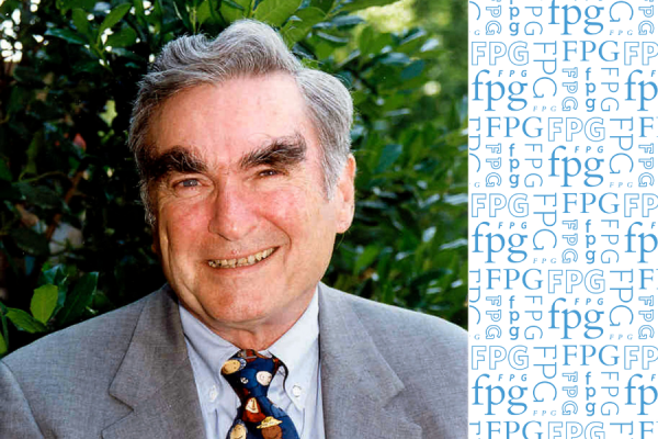 Headshot of former FPG dicrector James J. Gallagher wearing grey suit and dark tie in front of green shrubbery