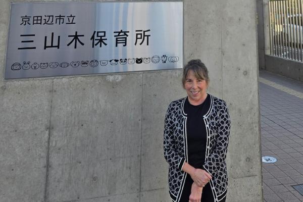 Jani Kozlowski stands outside building in Kyoto, Japan 