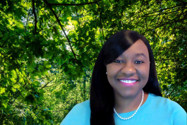 Jenille Morgan smiling at camera with trees behind her