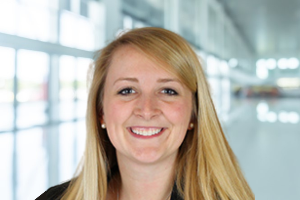 Tyler McFayden; woman with long blond hair stands in bright hallway