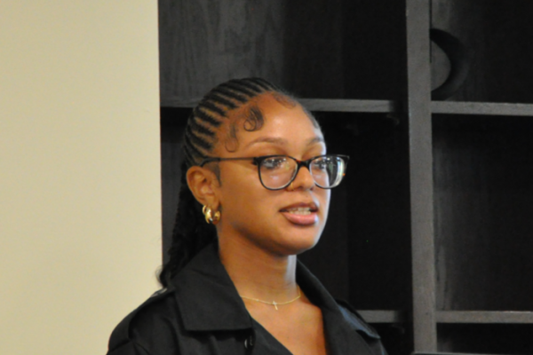 Kamora Coleman, young Black woman with glasses, giving a presentation