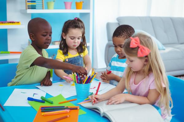 kindergarten kids enjoying arts and crafts together in a classroom