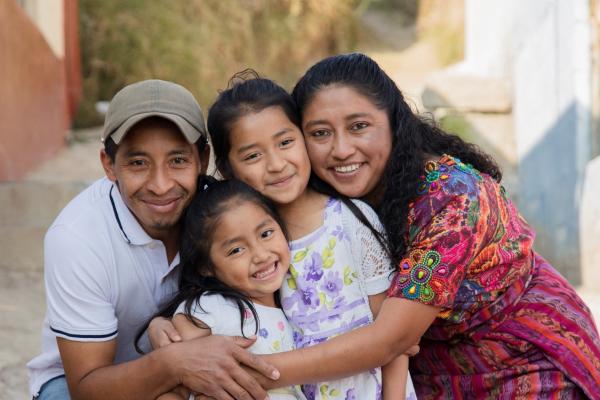 Portrait of a Latine family hugging in rural area 