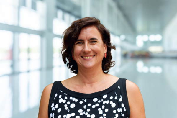 Melissa Lippold; woman with short wavy dark hair smiles at camera