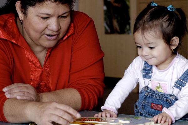 Adult and young child playing with a puzzle