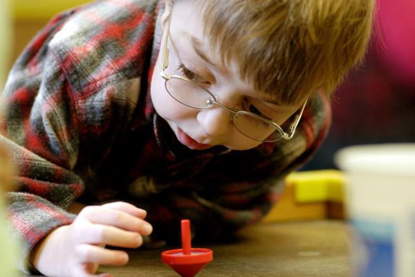 Young boy with a spinning top