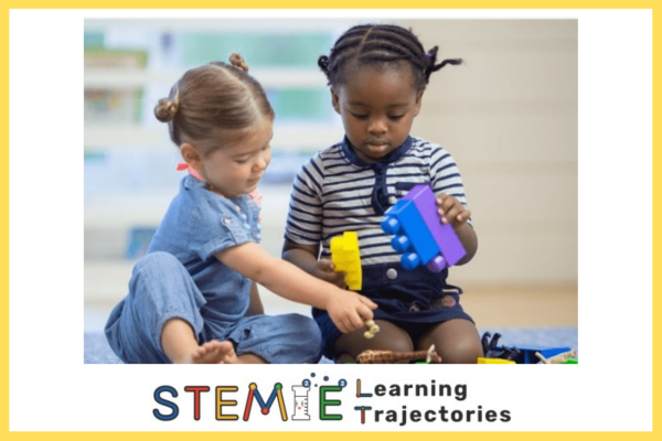 two children playing on floor; STEMIE learning trajectories logo across bottom of picture