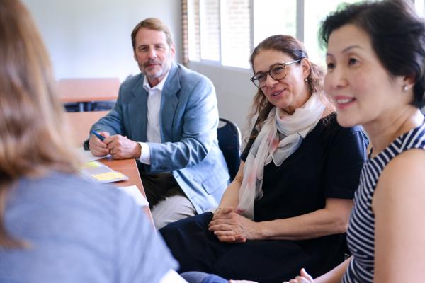 Four adults meeting at a table