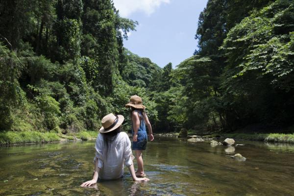 Mother and daughter playing in mountain stream
