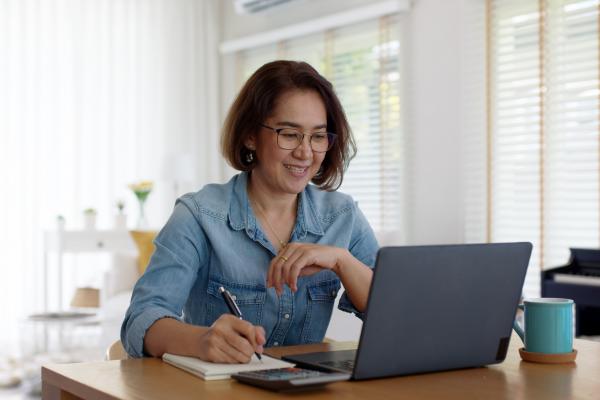 lady sits at desk table working at home doing digital training