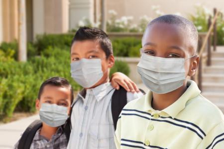 Three children wearing masks