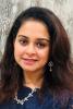 Nupur Mishra; woman wih long brown hair smiles at camera