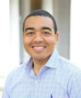 Brian Boyd; man with black hair wearing light blue button down shirt smiles at camera