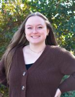 Hannah Netschytailo; woman with long dark hair smiles at camera