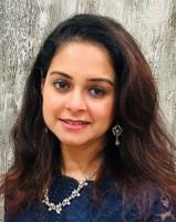 Nupur Mishra; woman wih long brown hair smiles at camera