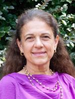 aysenil belger; woman with long dark hair wears fuchsia blouse