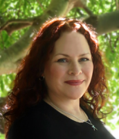 Sonya Abbate; woman with long curly auburn hair smiles at camera